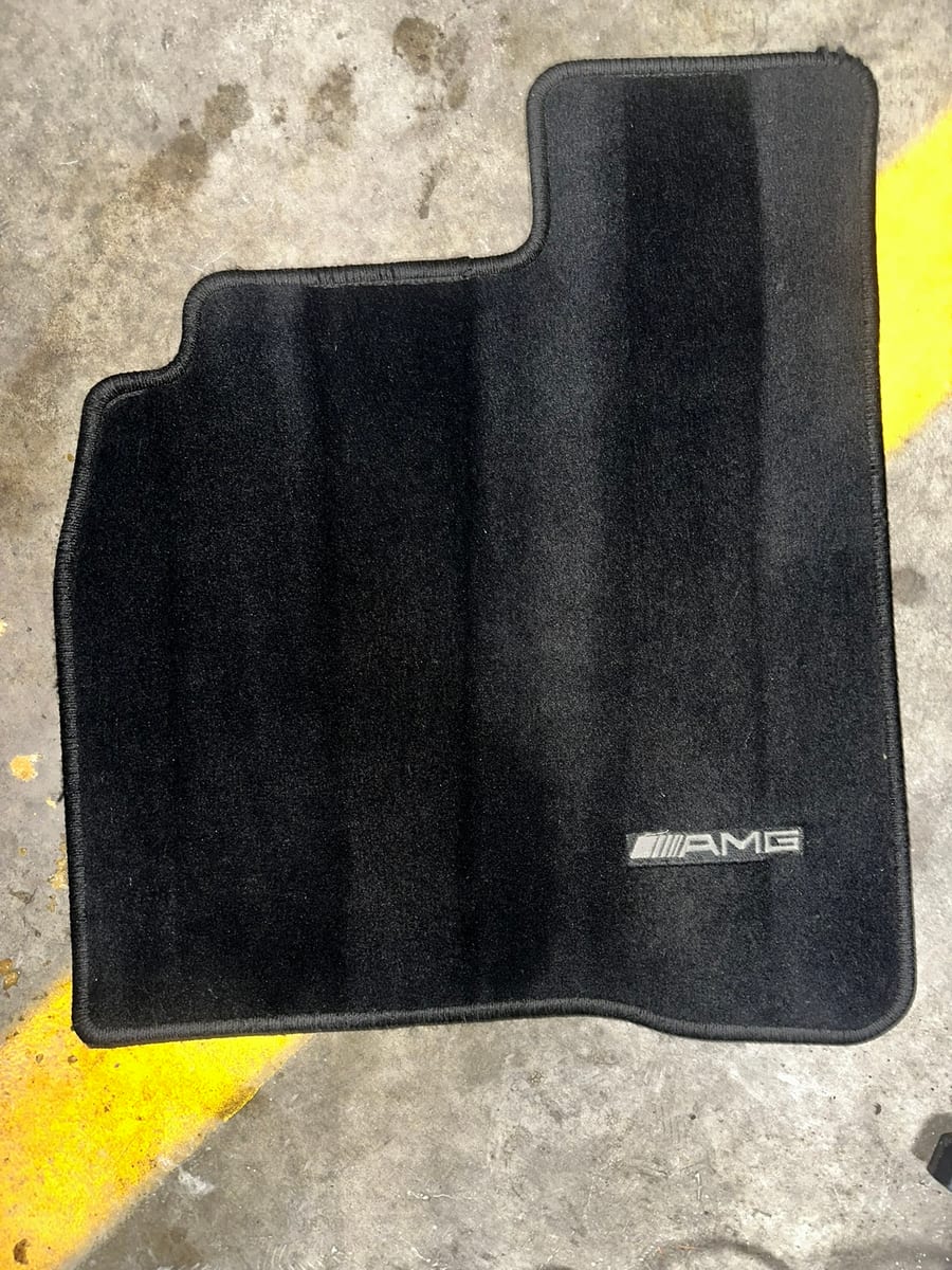 Mercedes AMG floor mat restored to clean black after extraction